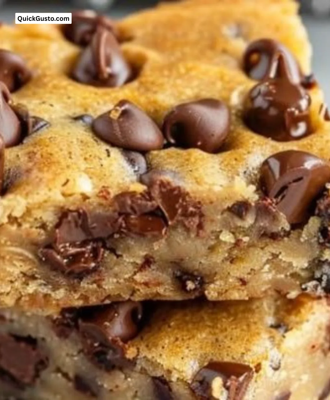 Freshly baked Banana Chocolate Chip Blondies on a cooling rack.