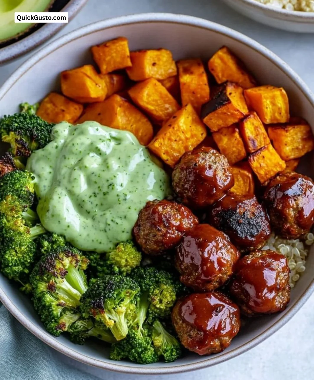 Delicious barbecue meatball bowls topped with avocado goddess sauce.