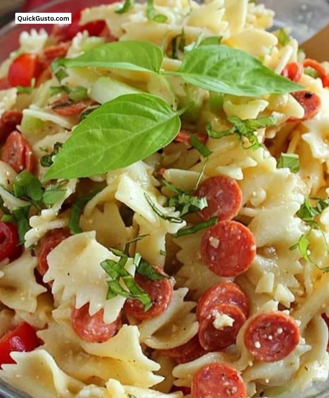 Delicious bowl of best pasta salad with fresh vegetables and dressing
