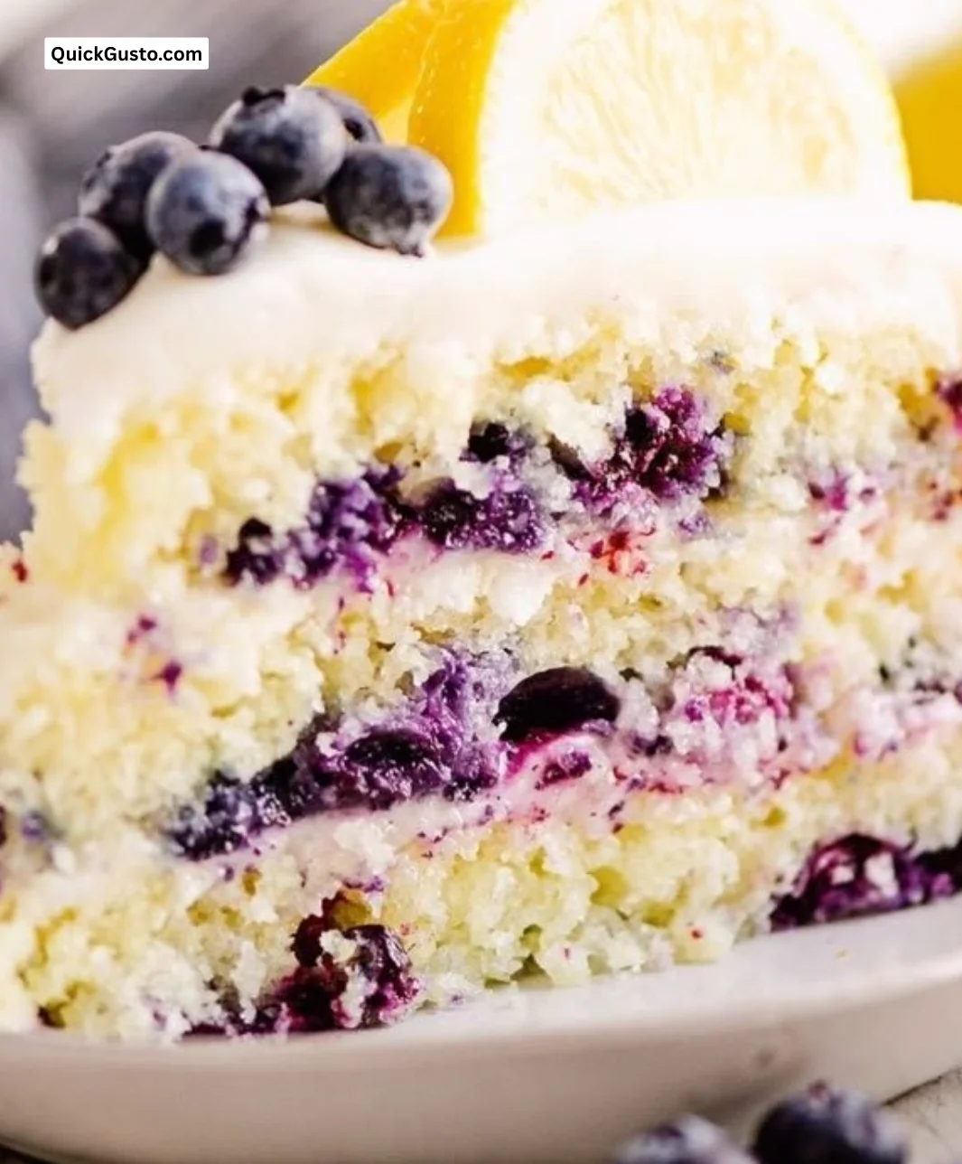 Delicious blueberry lemon layer cake with fresh berries on top