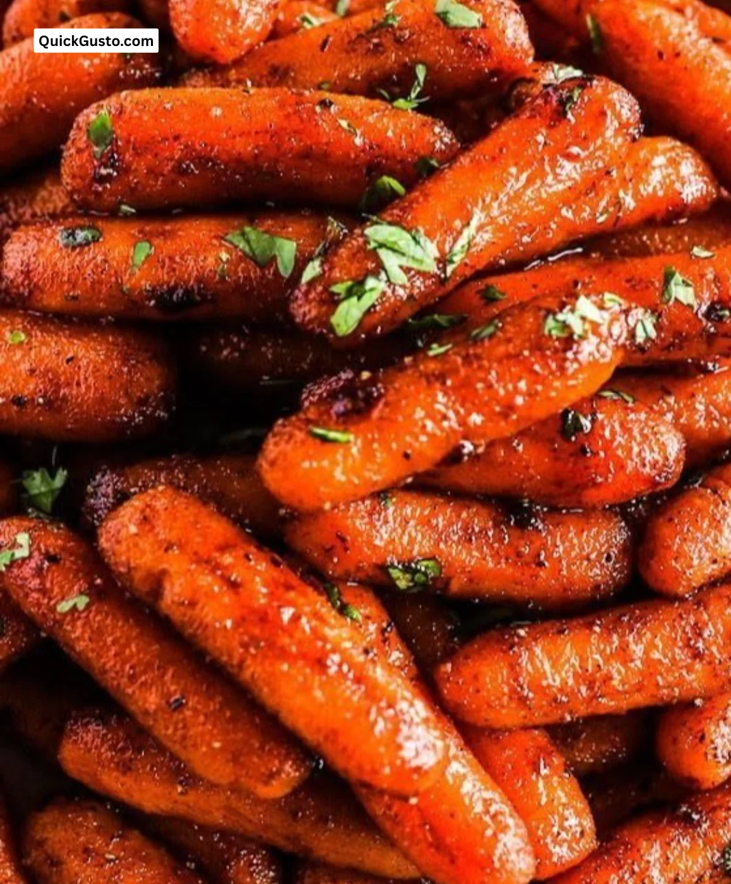 Sweet brown sugar roasted carrots served in a dish, garnished with herbs.