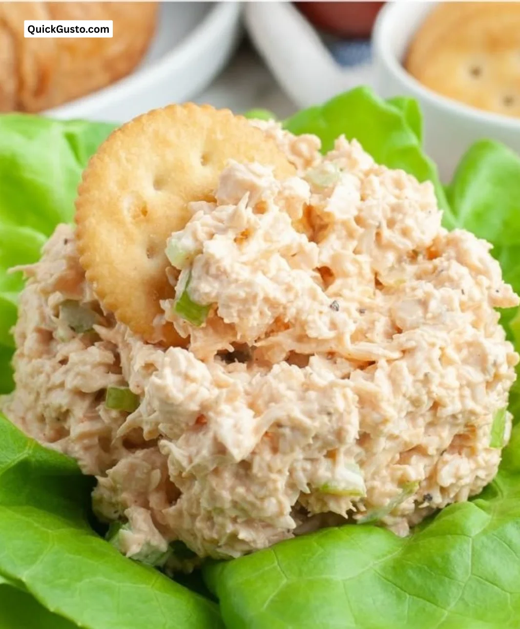 A colorful bowl of Buffalo Chicken Salad topped with blue cheese and vegetables