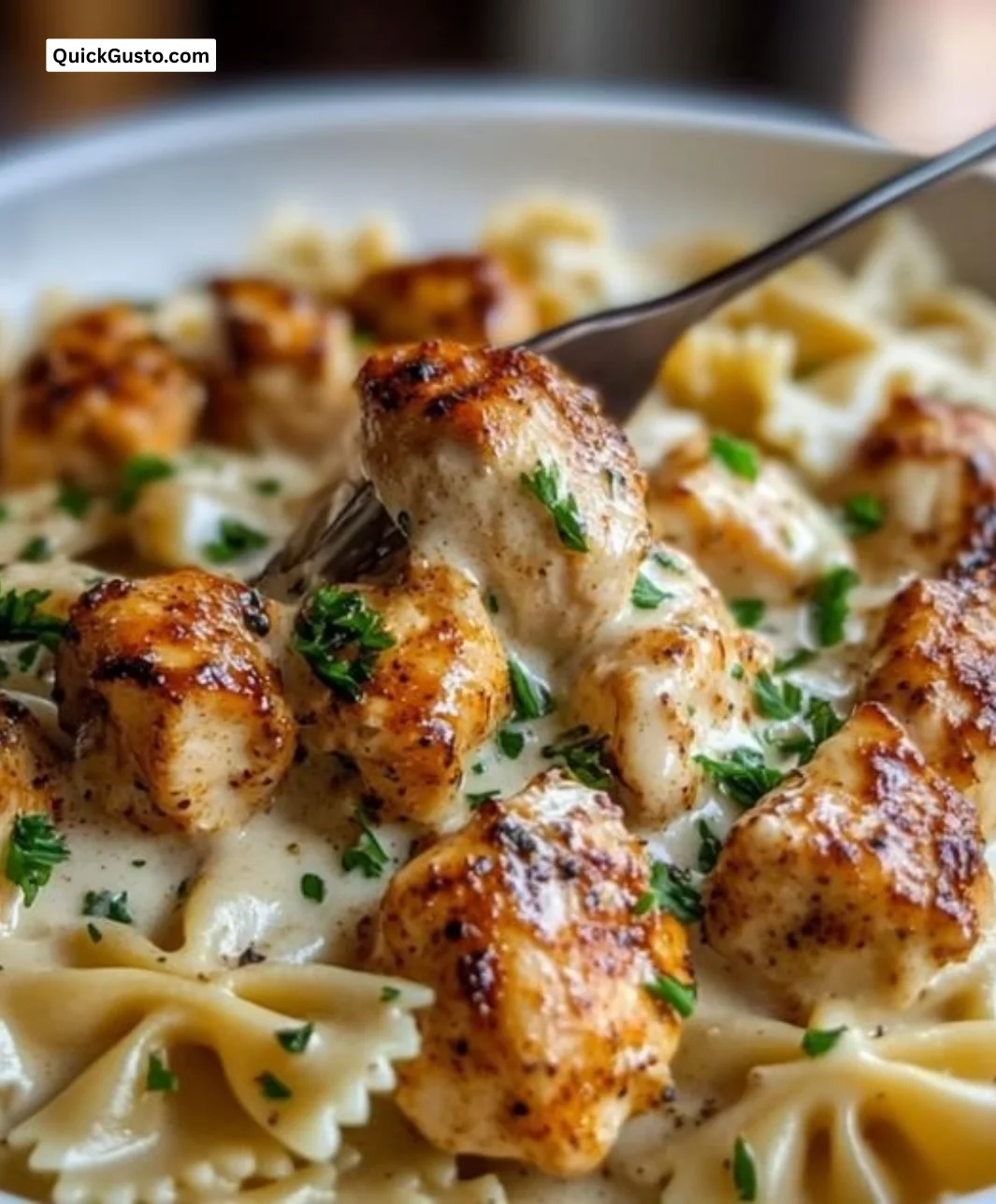 Creamy Cajun Chicken Alfredo Pasta served in a bowl with herbs and spices