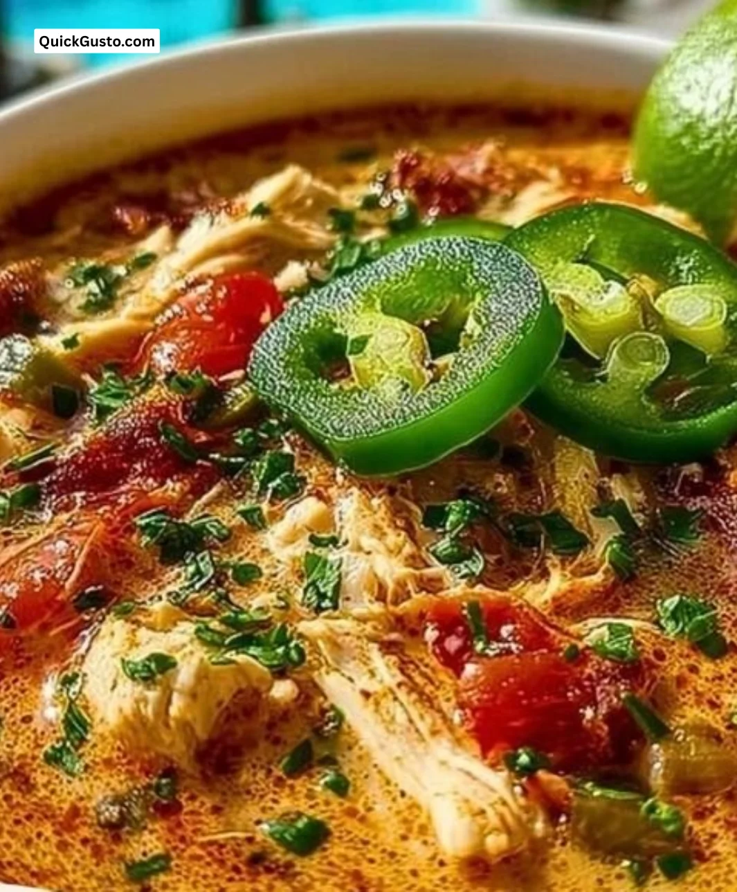 Bowl of Cajun White Chicken Chili garnished with fresh herbs