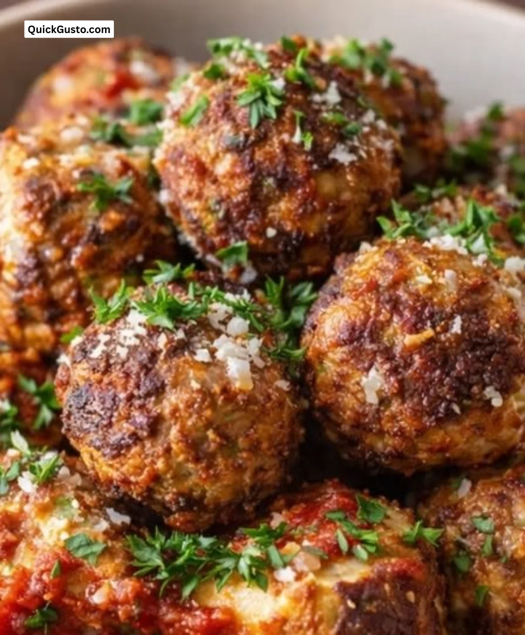 Plate of carnivore meatballs with ricotta cheese and fresh herbs.