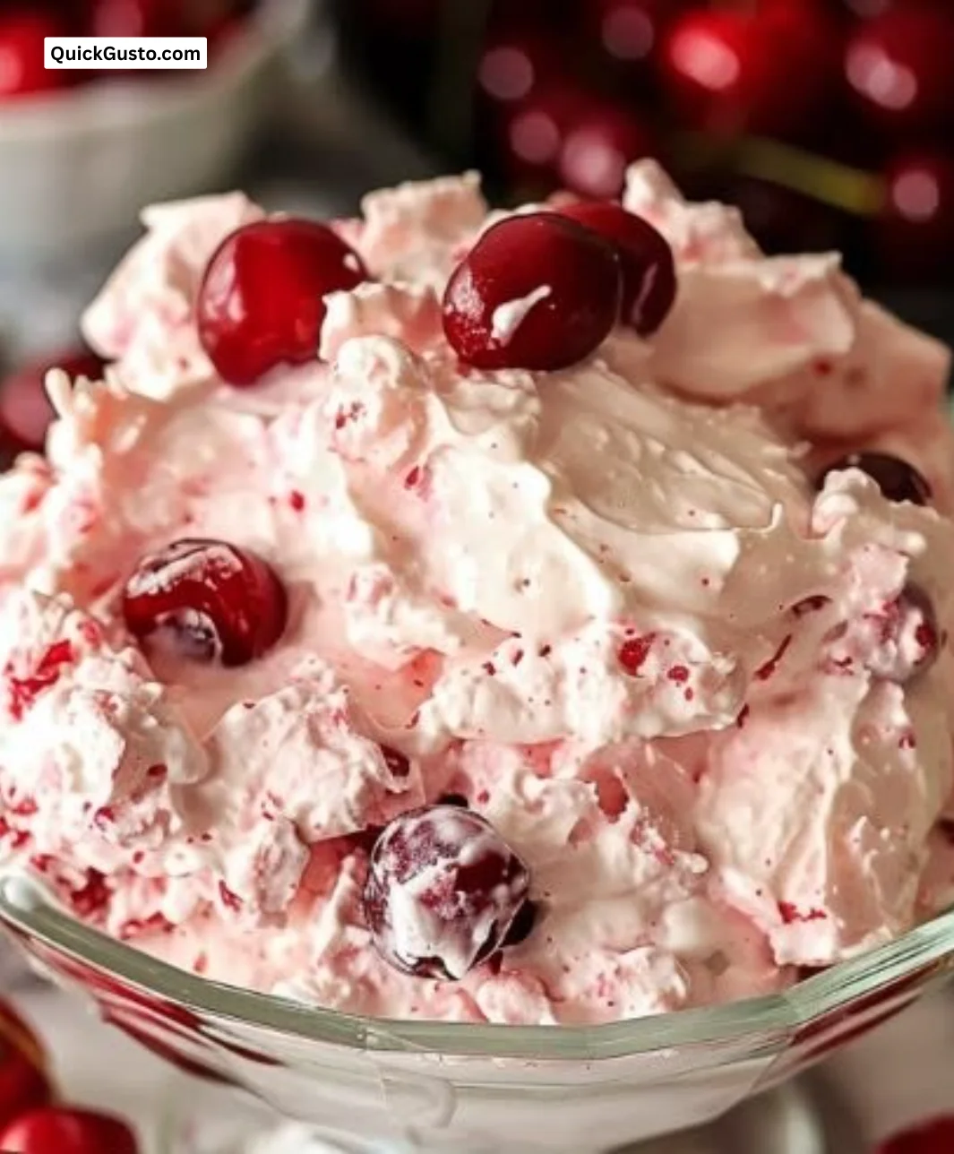 Delicious Cherry Cheesecake Fluff dessert in a bowl with cherries on top