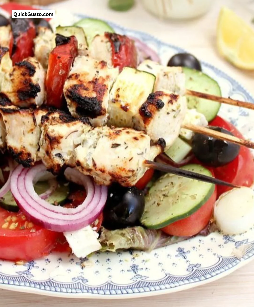 Plate of Chicken Souvlaki with fresh vegetables and dipping sauce