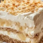 Delicious Coconut Icebox Cake topped with coconut flakes and whipped cream