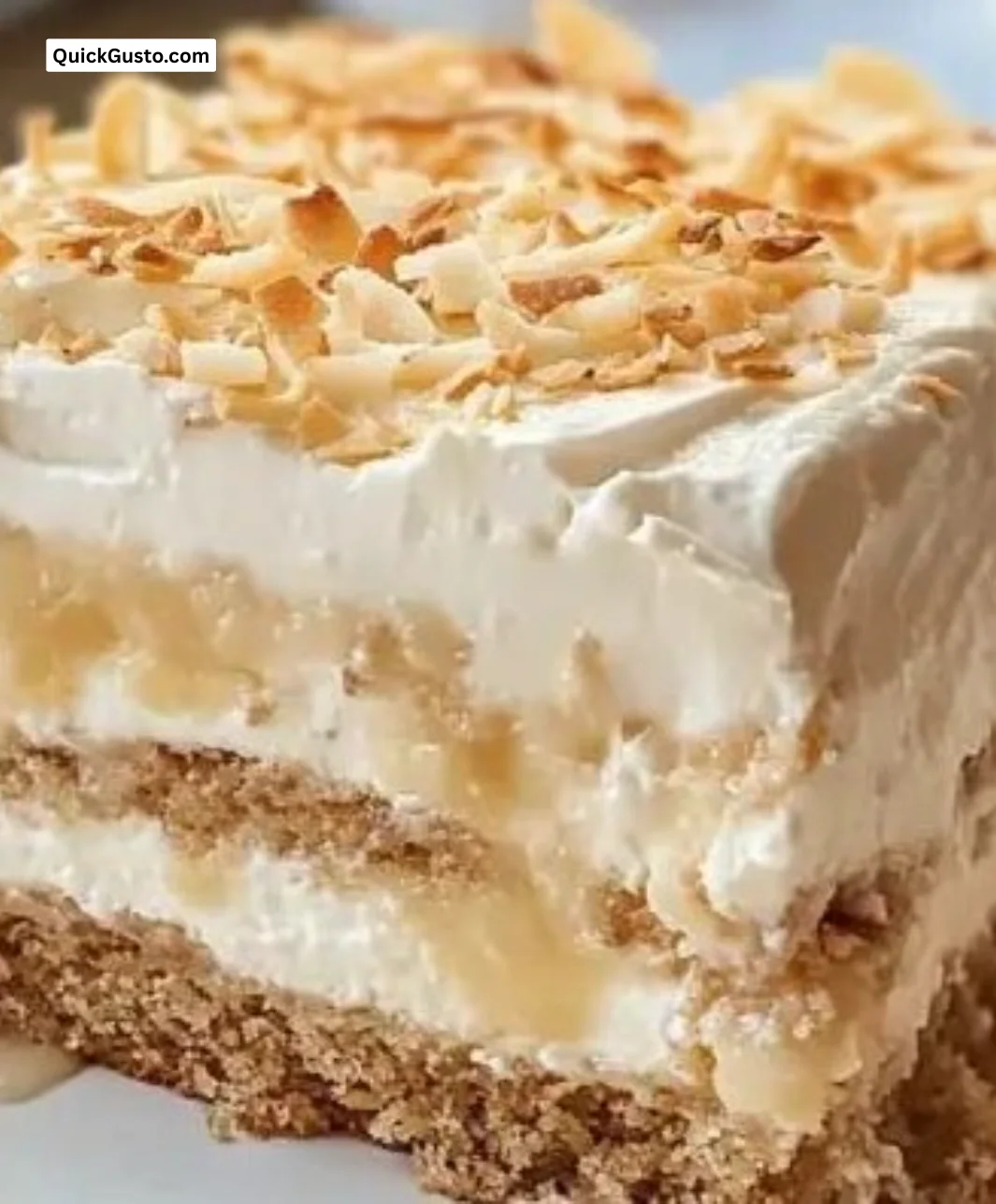 Delicious Coconut Icebox Cake topped with coconut flakes and whipped cream