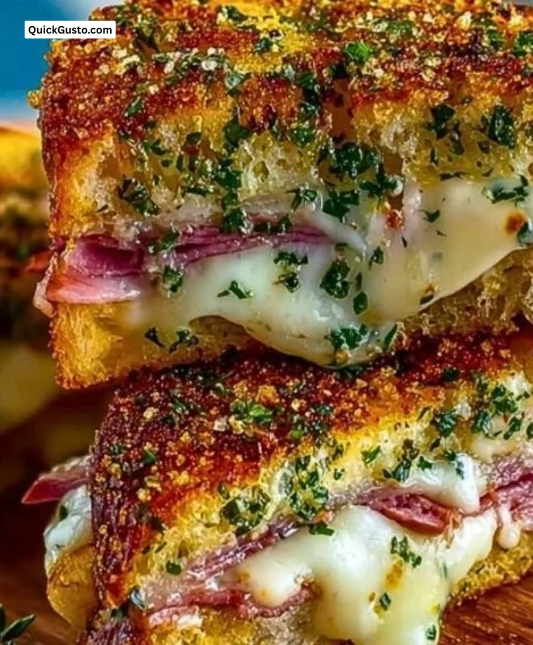 Cuban garlic bread sandwich with filling ingredients on a rustic table.