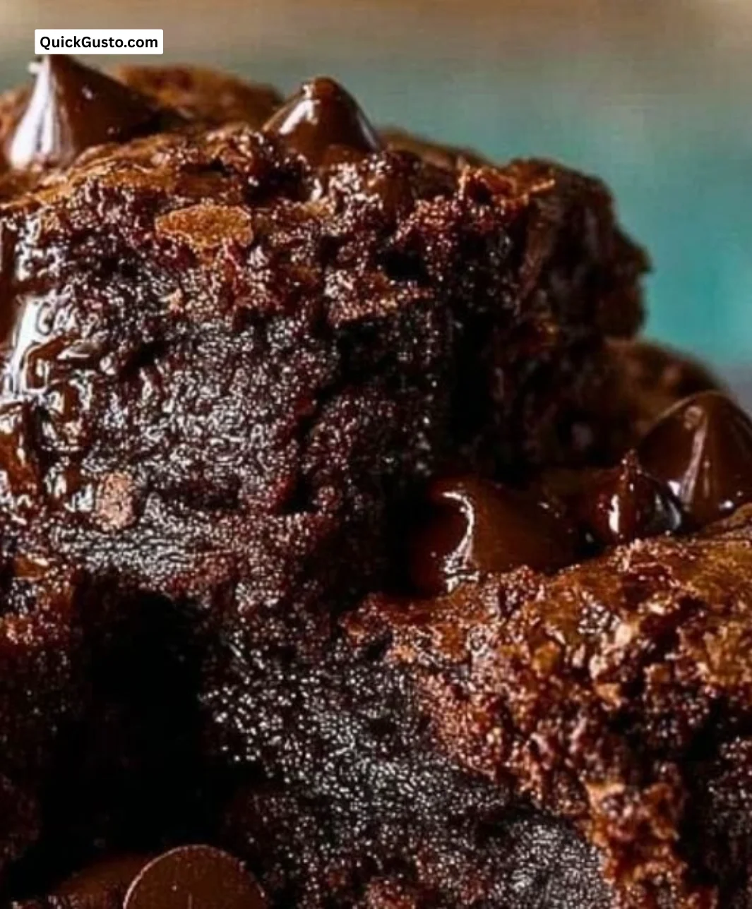 A plate of rich, decadent brownies topped with chocolate drizzle and nuts.