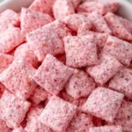 Bowl of Strawberry Shortcake Puppy Chow, a no-bake crunchy treat