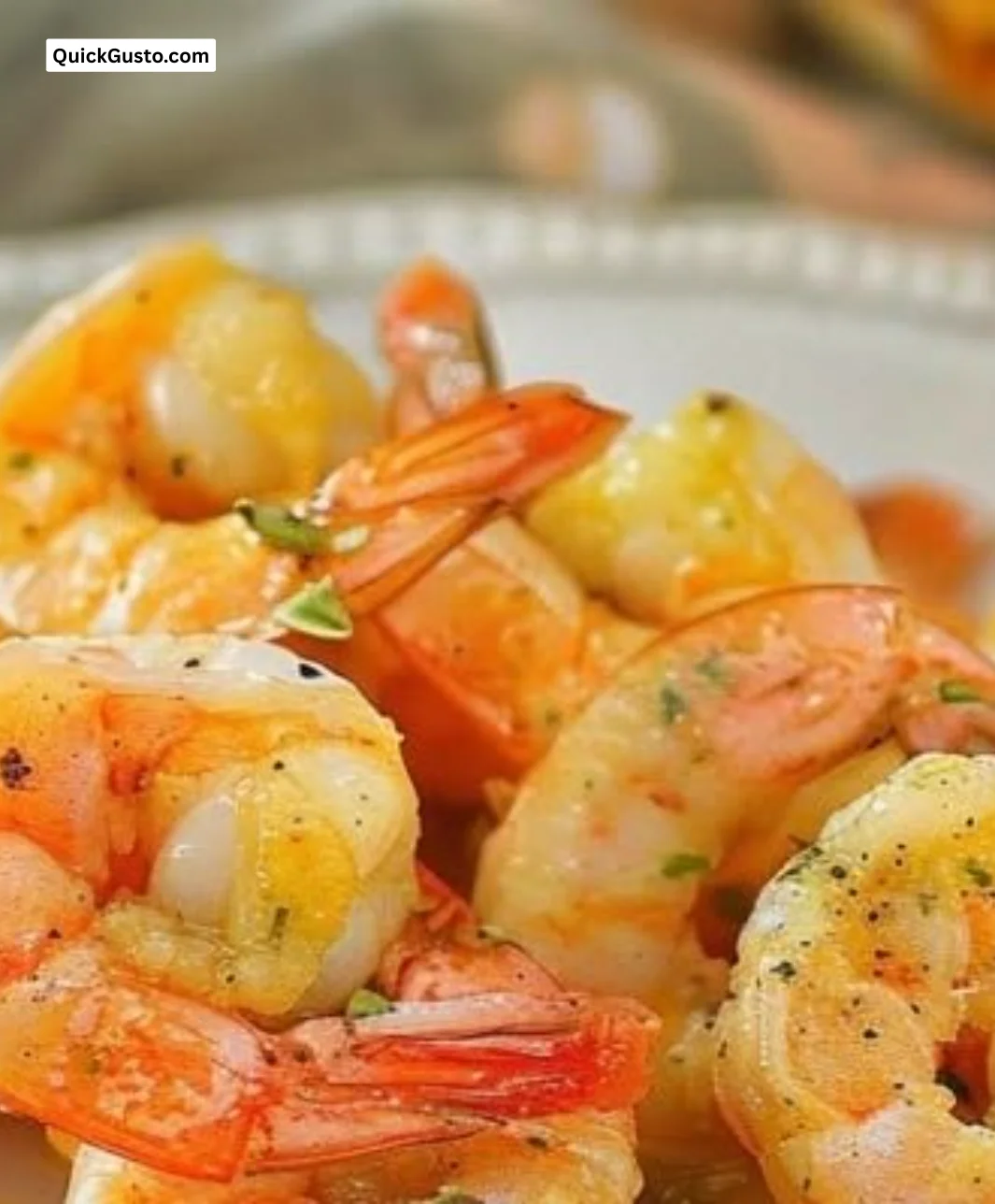 Delicious Garlic Parmesan Roasted Shrimp served on a plate with herbs