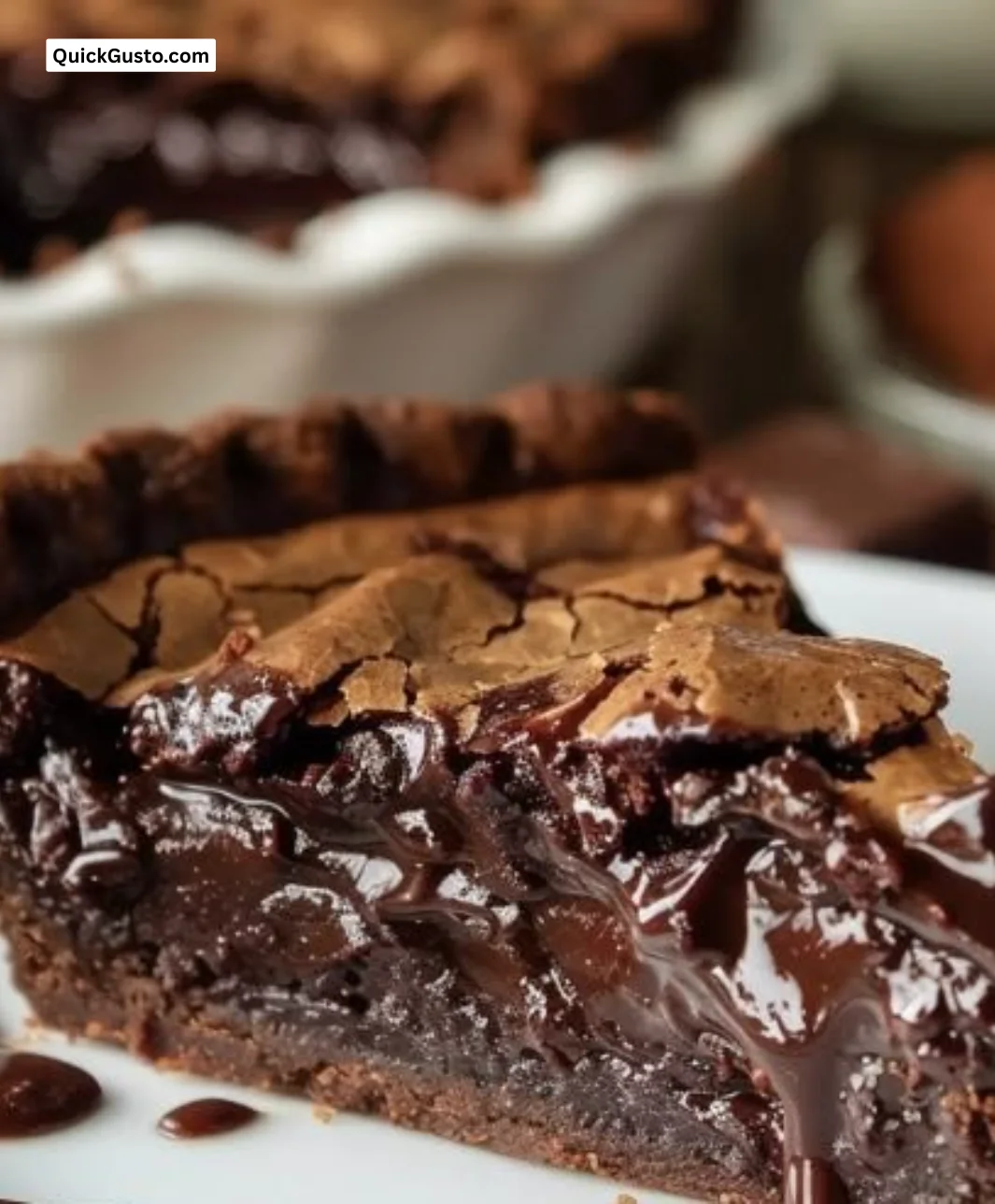 Gooey brownie pie topped with chocolate and walnuts on a plate