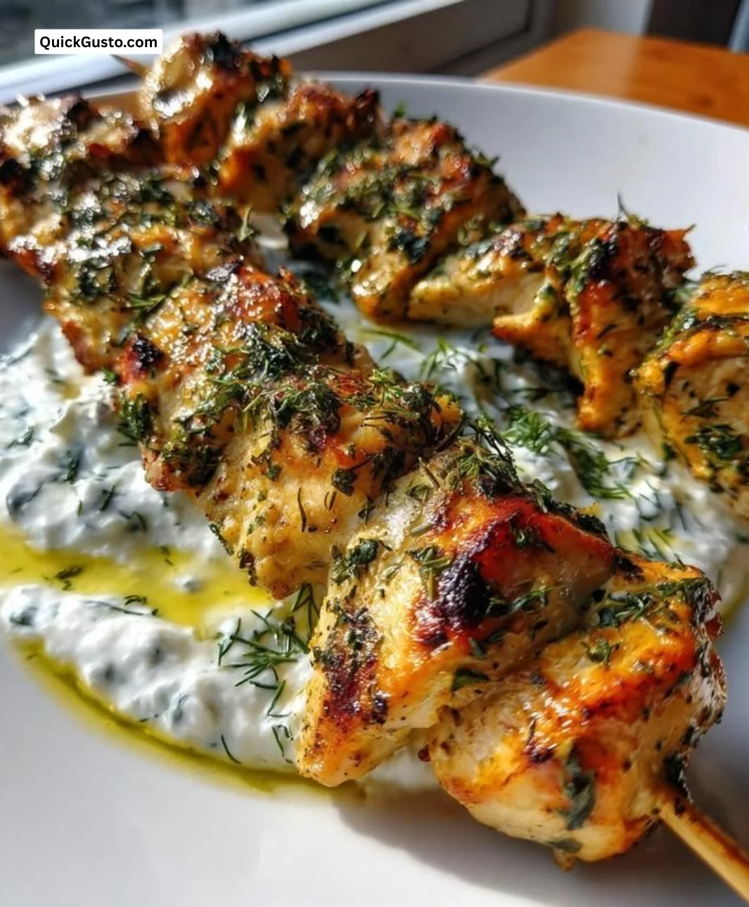 Plate of Greek Chicken Souvlaki served with fresh tzatziki sauce and vegetables