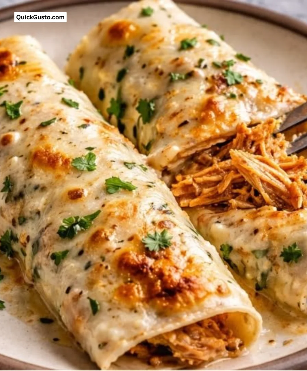 High protein chicken enchiladas topped with cheese and fresh herbs