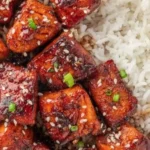 Delicious honey glazed salmon bites served on a platter.