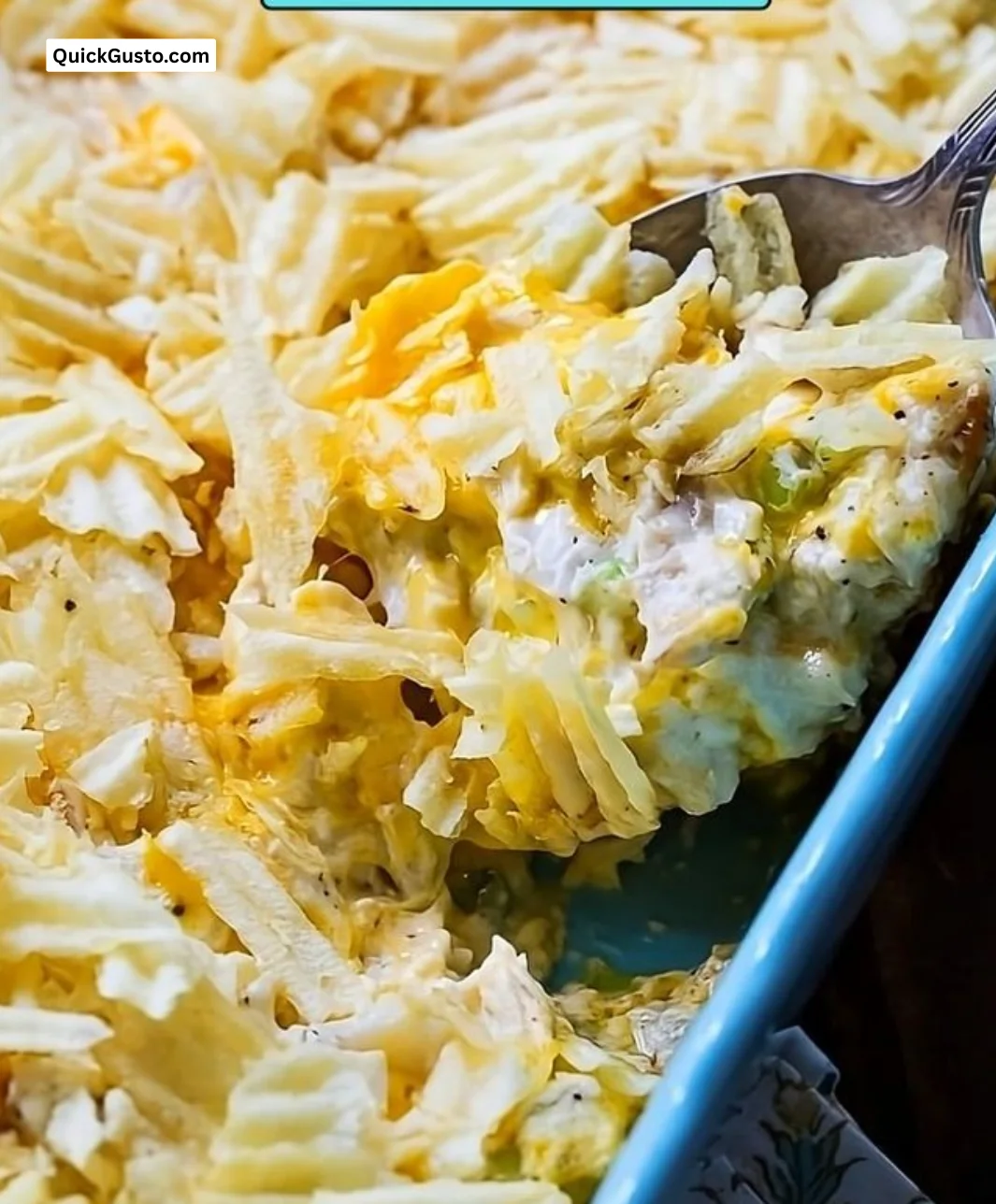 Delicious hot chicken salad served in a bowl with fresh ingredients.