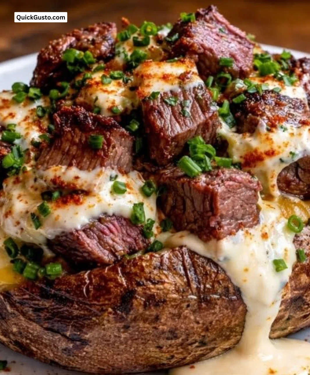 Delicious loaded baked potato topped with steak bites and cheese
