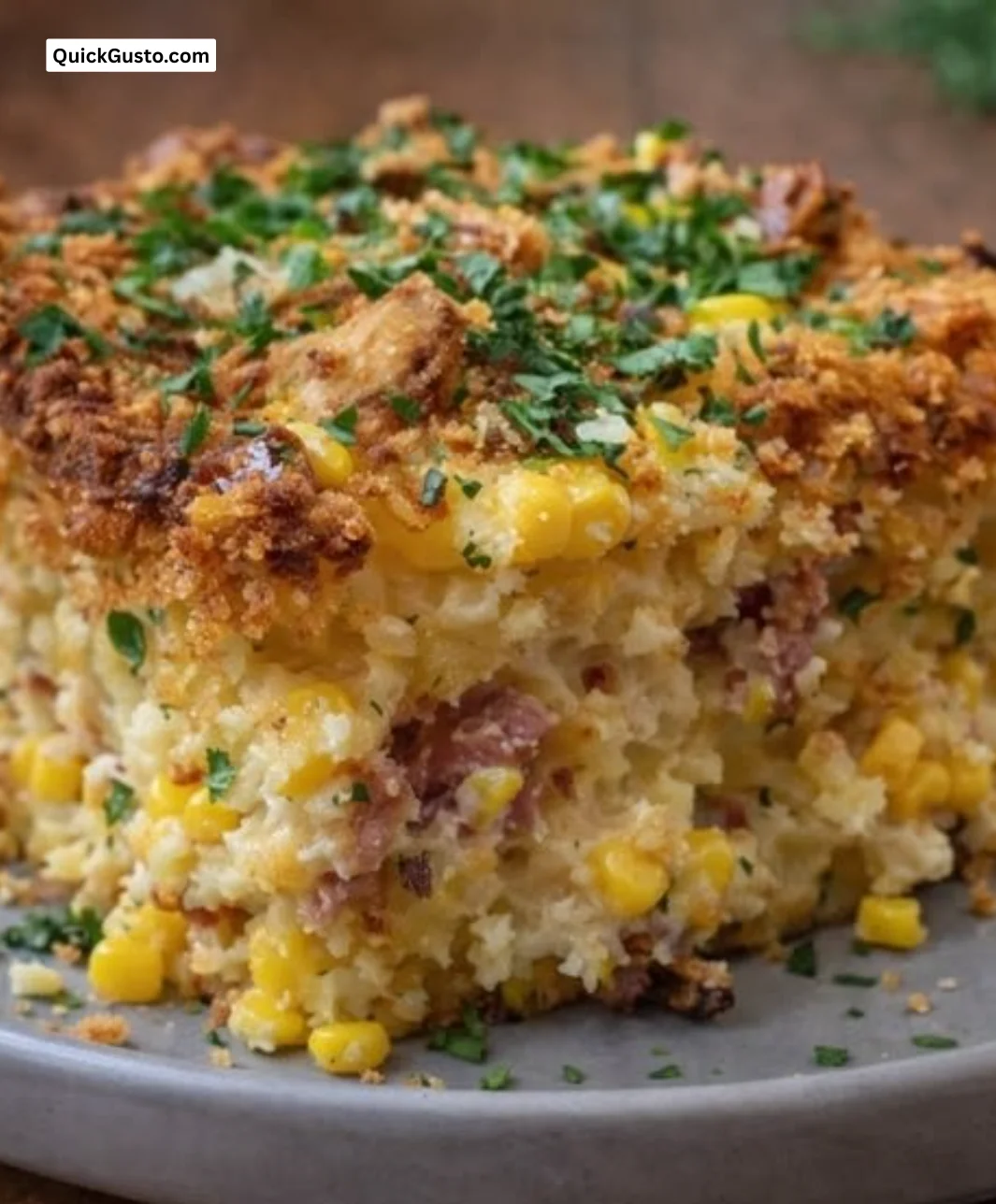 Loaded Cornbread Casserole with cheese and toppings in a baking dish