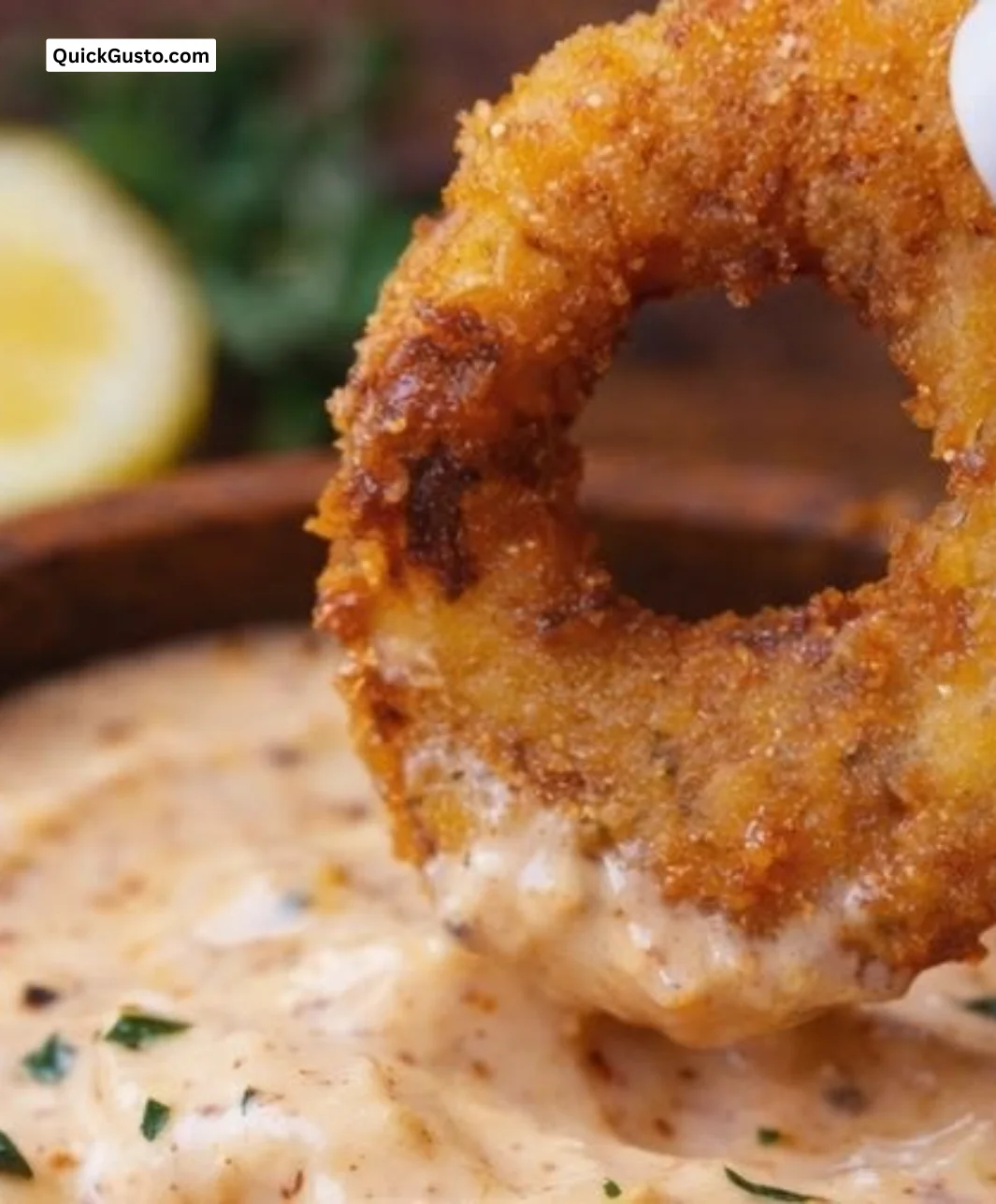 A bowl of Louisiana remoulade sauce garnished with herbs, perfect for seafood.