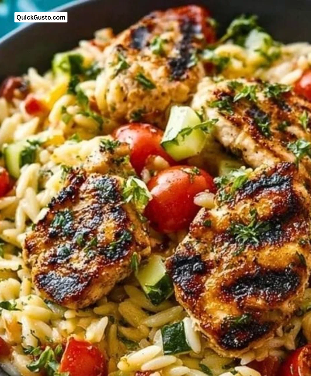 Mediterranean chicken orzo dish with fresh herbs and vegetables