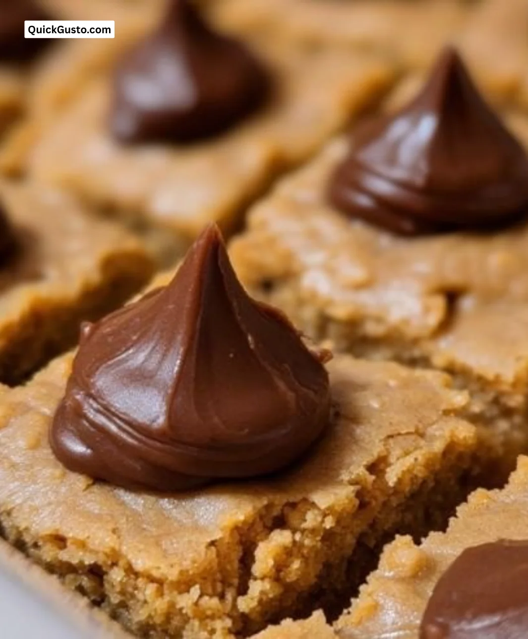 Delicious Peanut Butter Blossom Bars topped with chocolate kisses.