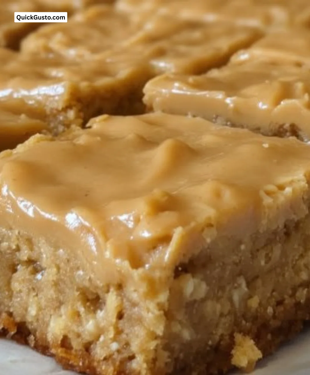 Delicious peanut butter cookie bars topped with chocolate chips on a plate.