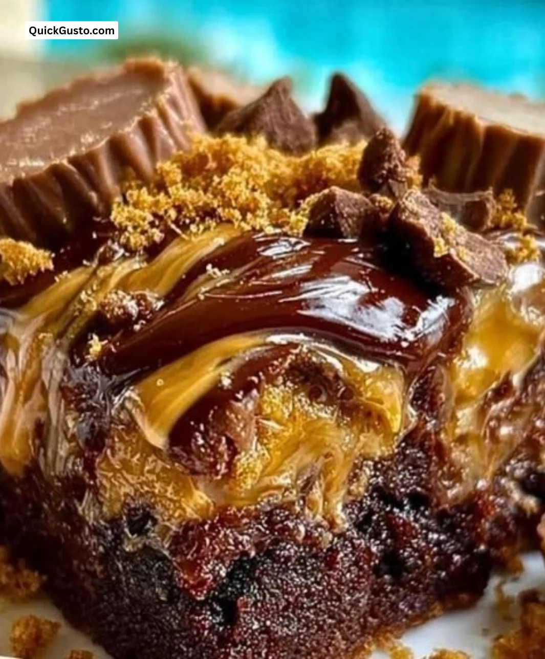 Delicious Peanut Butter Cup Dump Cake topped with chocolate and peanut butter cups.
