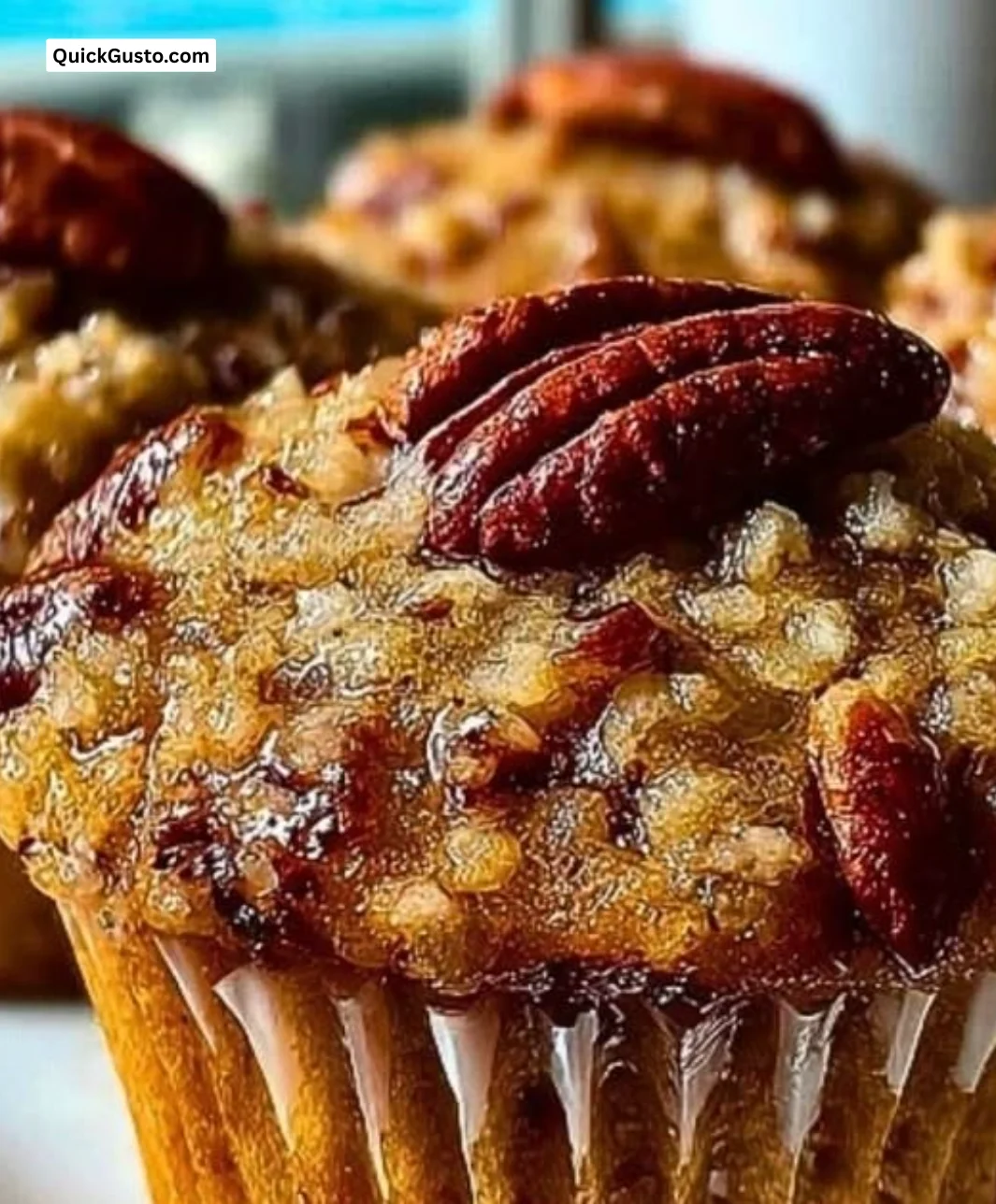 Delicious pecan pie brown sugar muffins topped with pecans and caramel drizzle