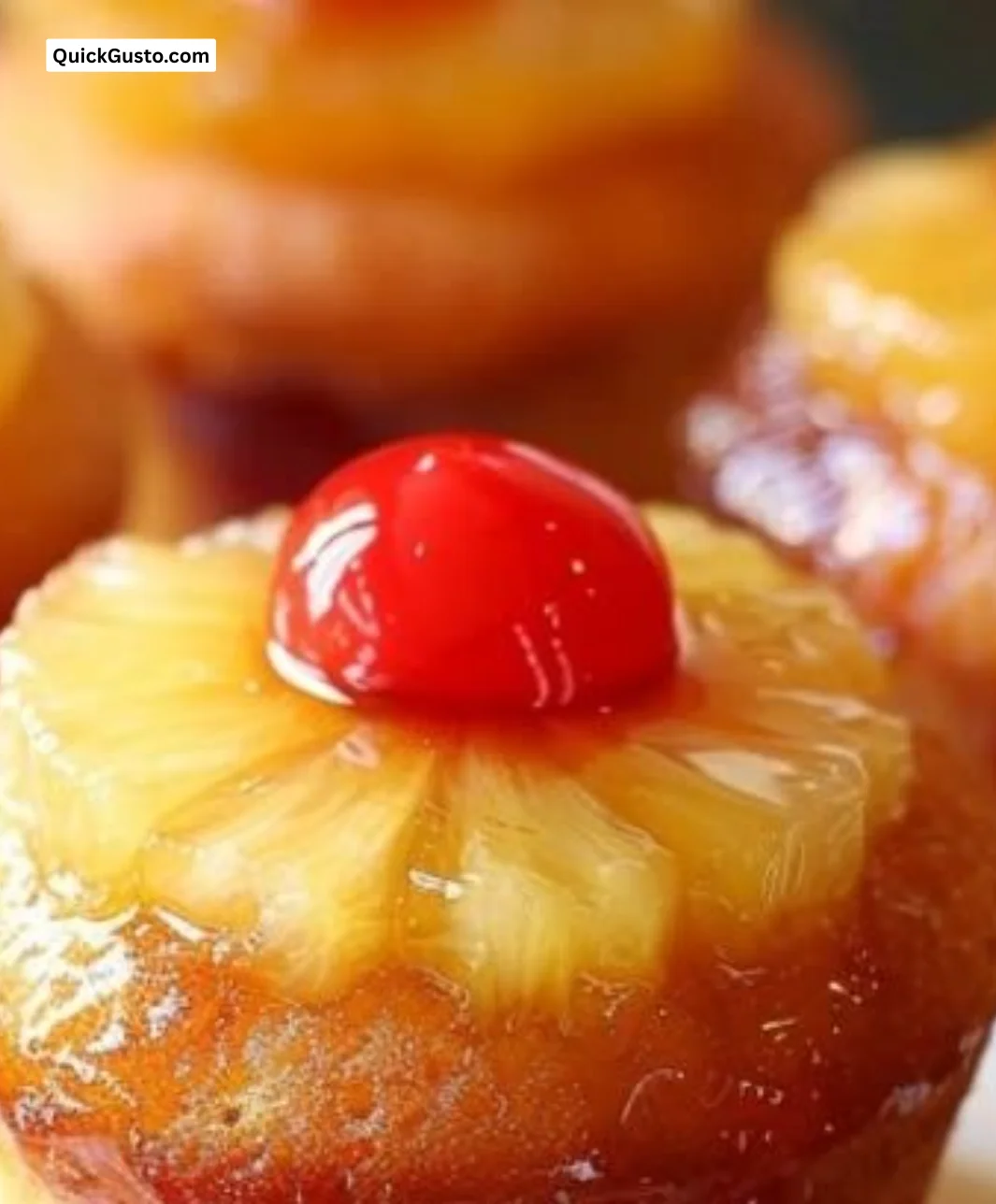 Pineapple Upside Down Cupcakes topped with caramelized pineapple and cherries
