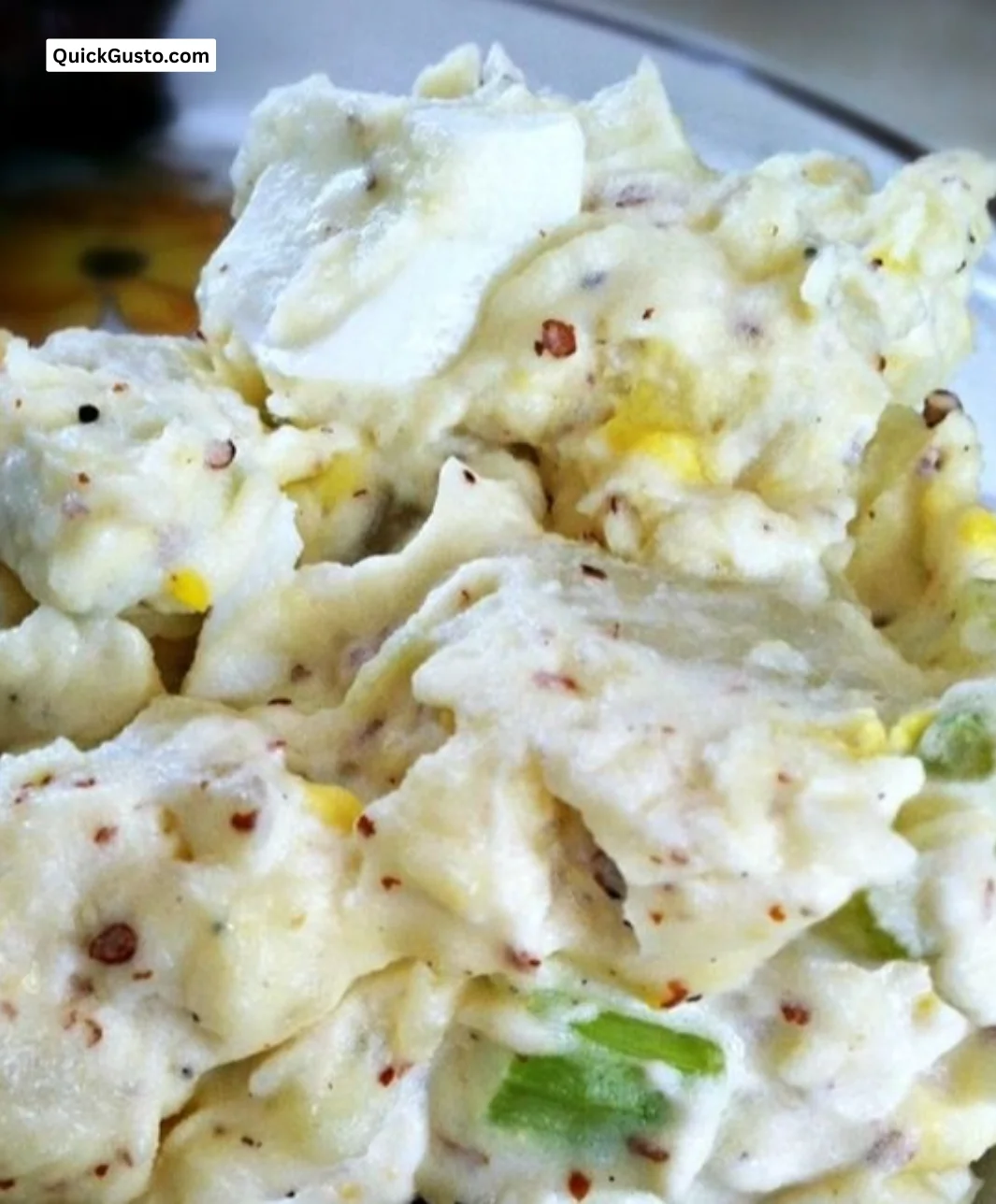 Delicious homemade potato salad served in a bowl with fresh herbs