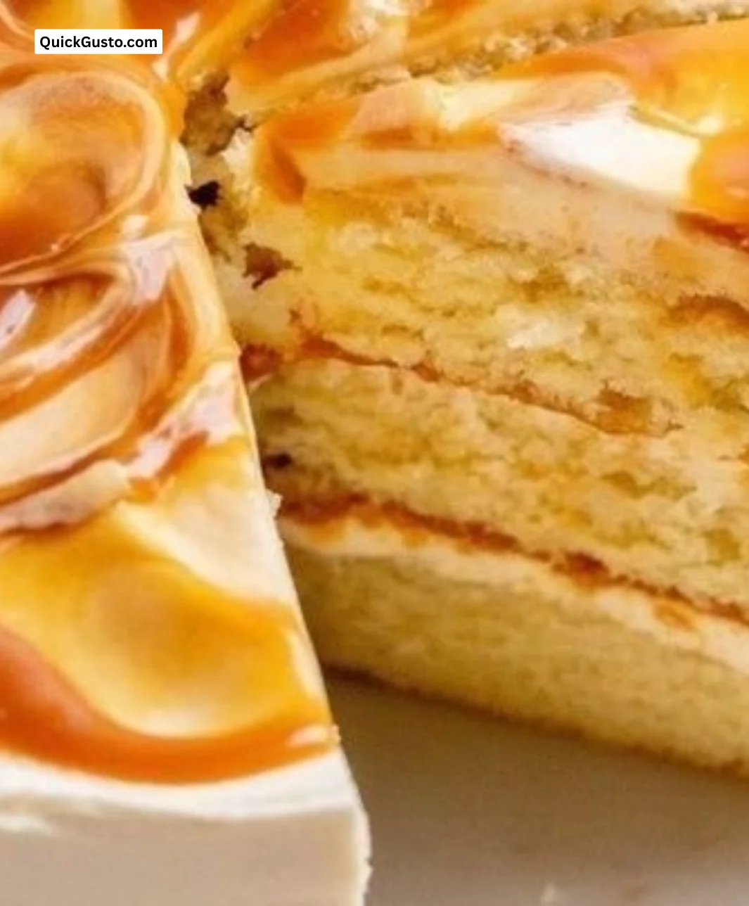 Slice of decadent Salted Caramel Cake with drizzling caramel on top
