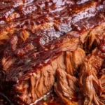 Slow cooker Texas beef brisket dish served with sides and garnishes