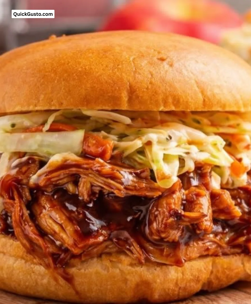 Succulent smoky BBQ pulled chicken served with buns and coleslaw on a plate.