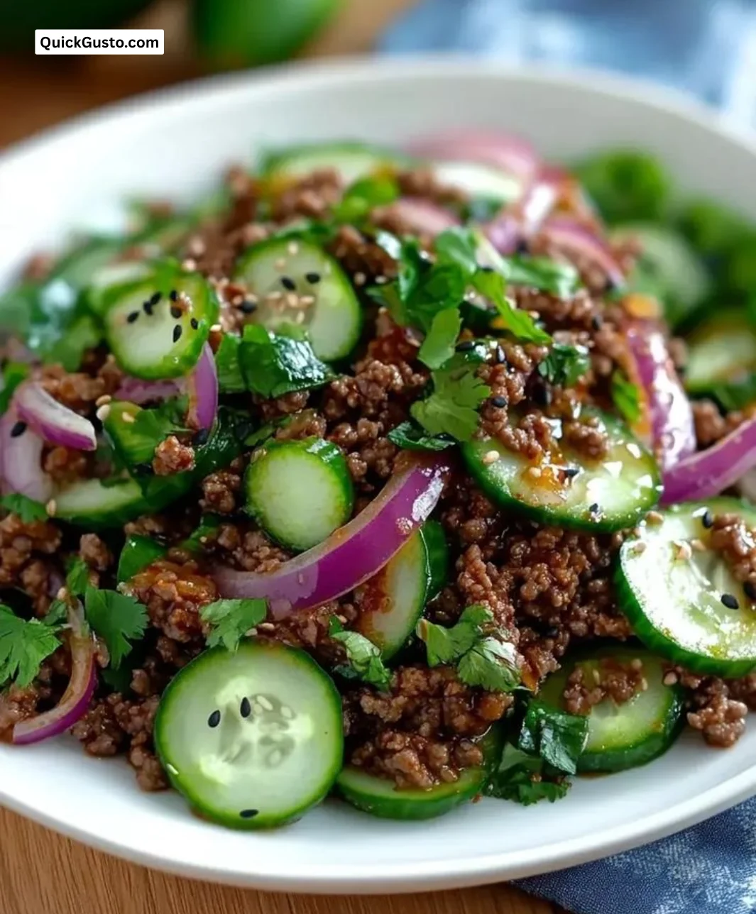Spicy Korean ground beef dish served with a side of cucumber salad