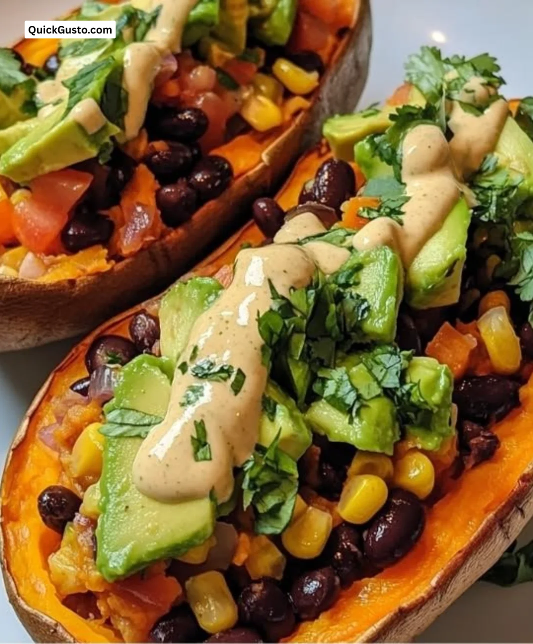 Stuffed sweet potato with avocado, black beans, and cilantro lime cream drizzle