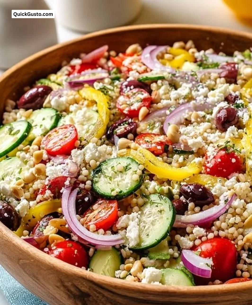 Bright and easy Greek couscous salad with fresh vegetables and herbs