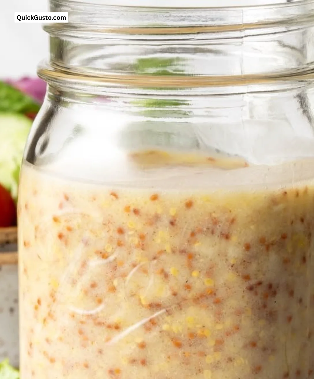 Bright Golden Honey Mustard Dressing in a jar with fresh ingredients