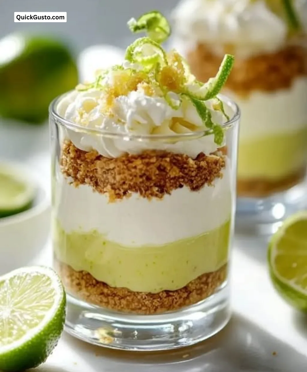 Bright no-bake key lime pie parfaits served in clear glasses with lime zest.