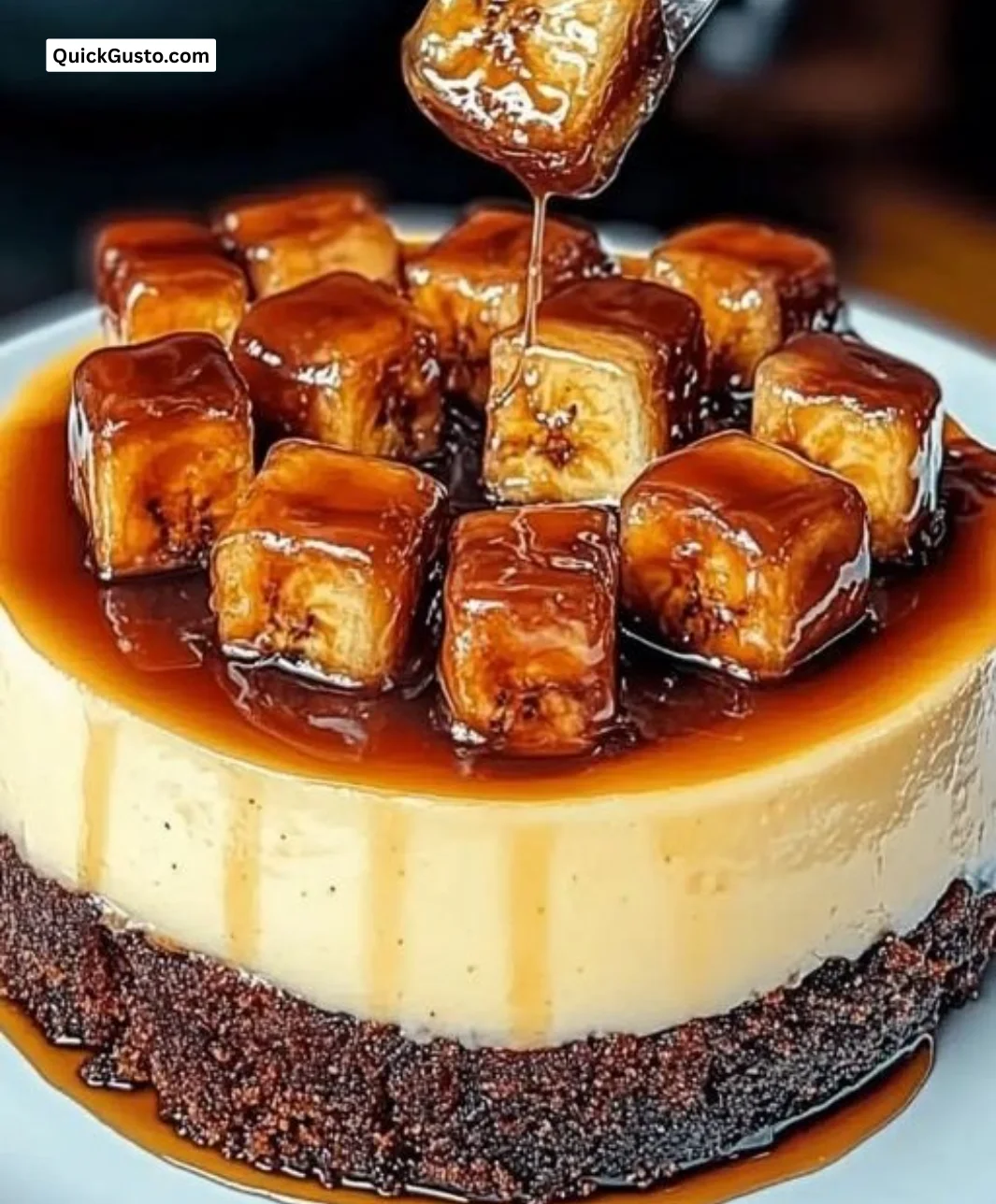 Delicious caramelized banana cheesecake topped with rum glaze, showcasing indulgent layers.
