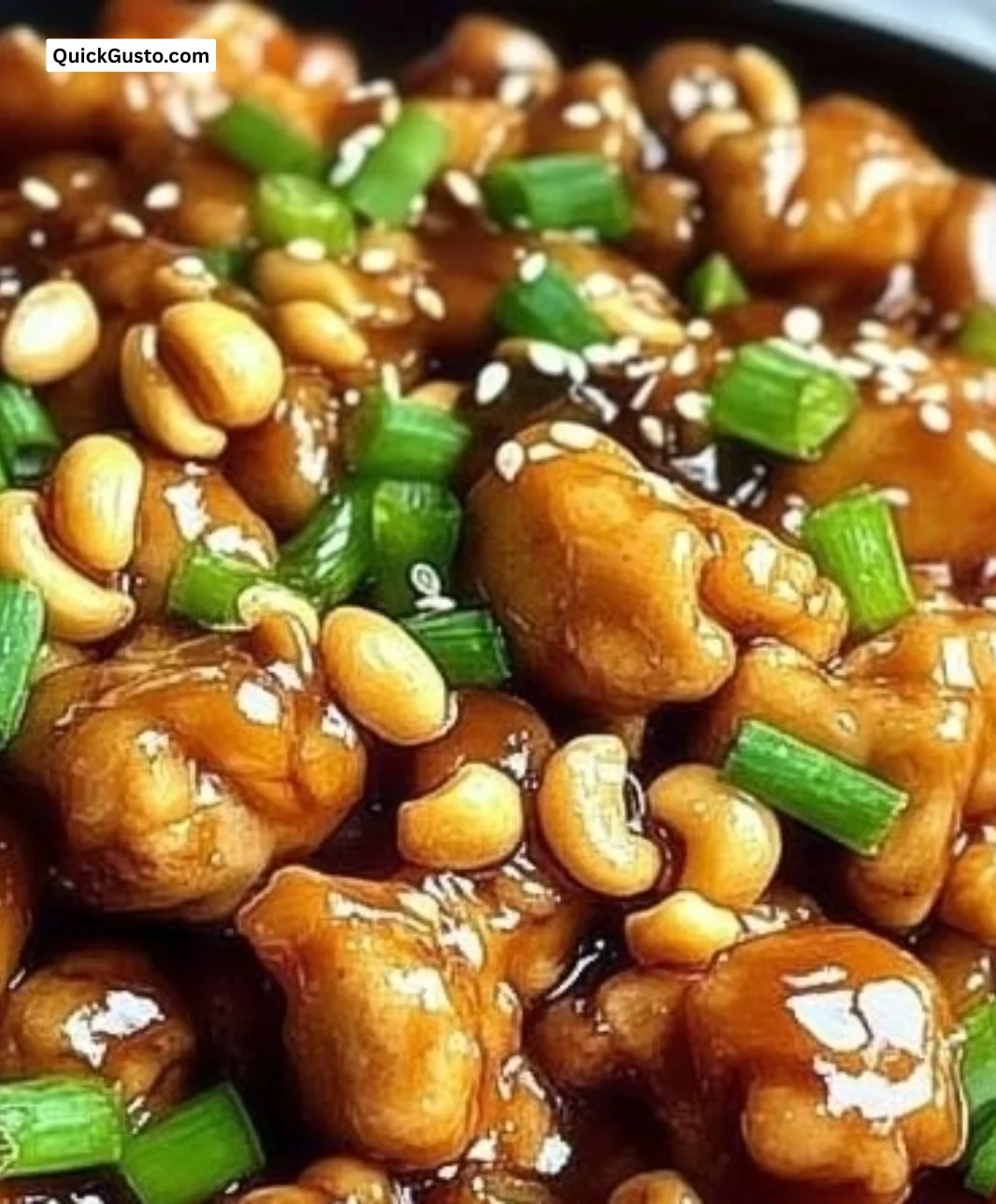 Delicious cashew chicken dish garnished with fresh vegetables and cashews.