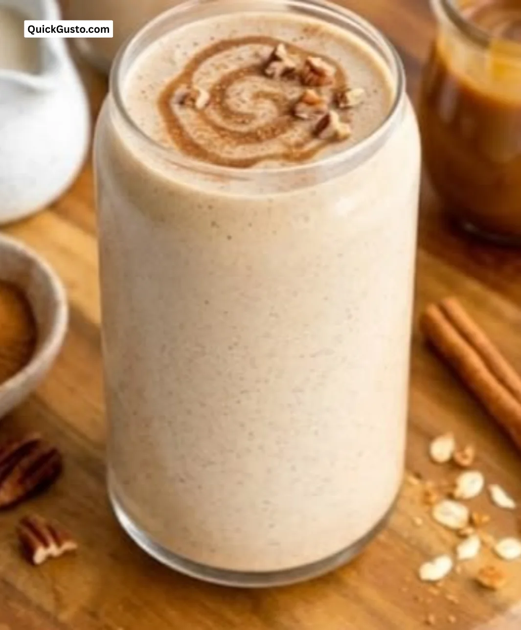 Delicious Cinnamon Roll Smoothie in a glass topped with cinnamon and cream.