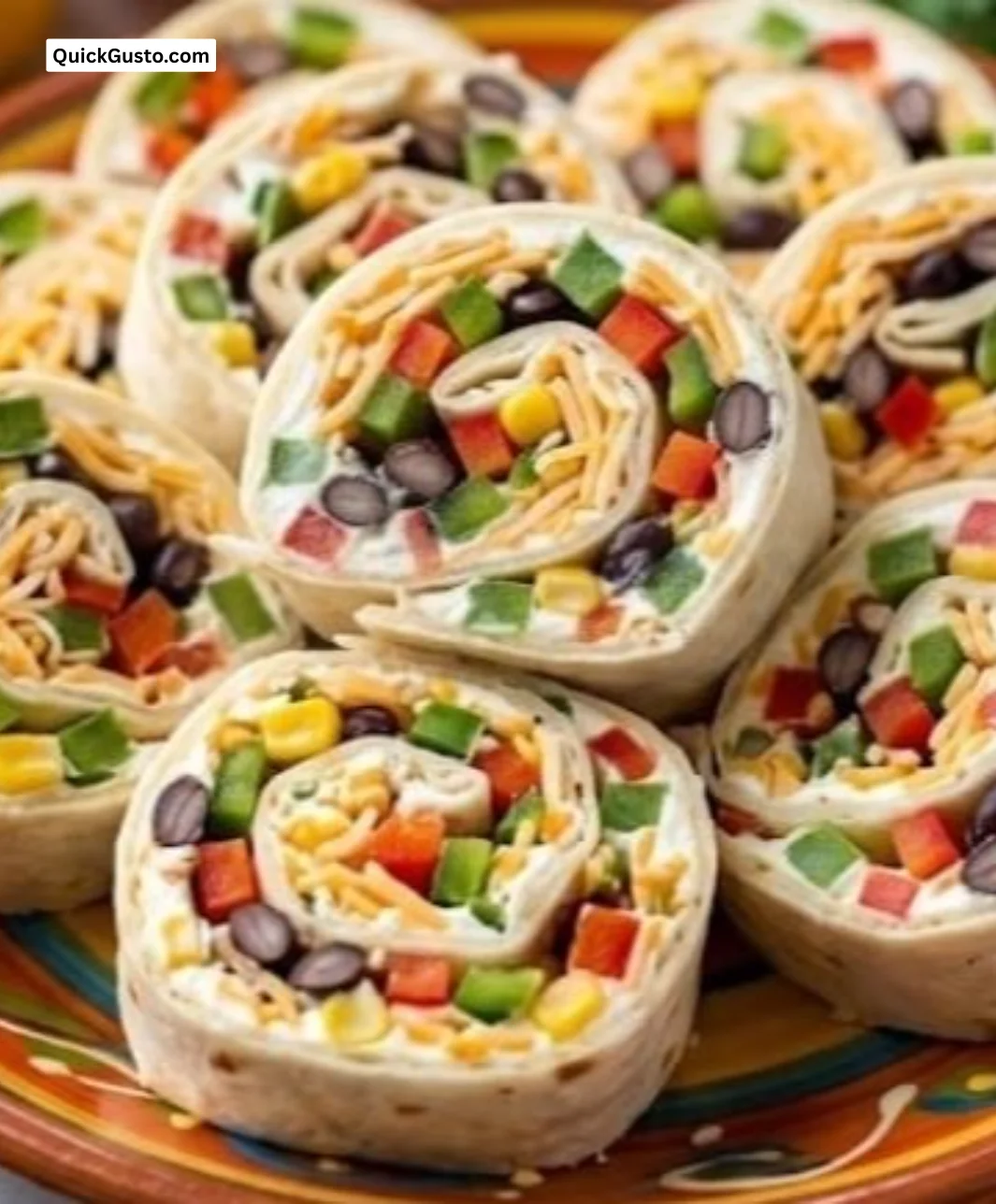 Plate of colorful Mexican Pinwheels filled with cheese and spices.