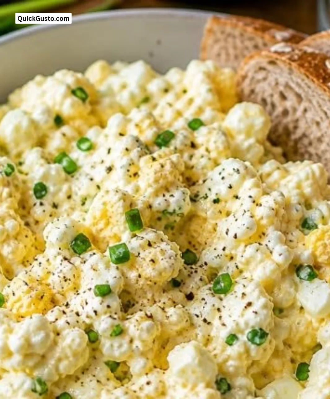Delicious cottage cheese egg salad in a bowl, garnished with herbs