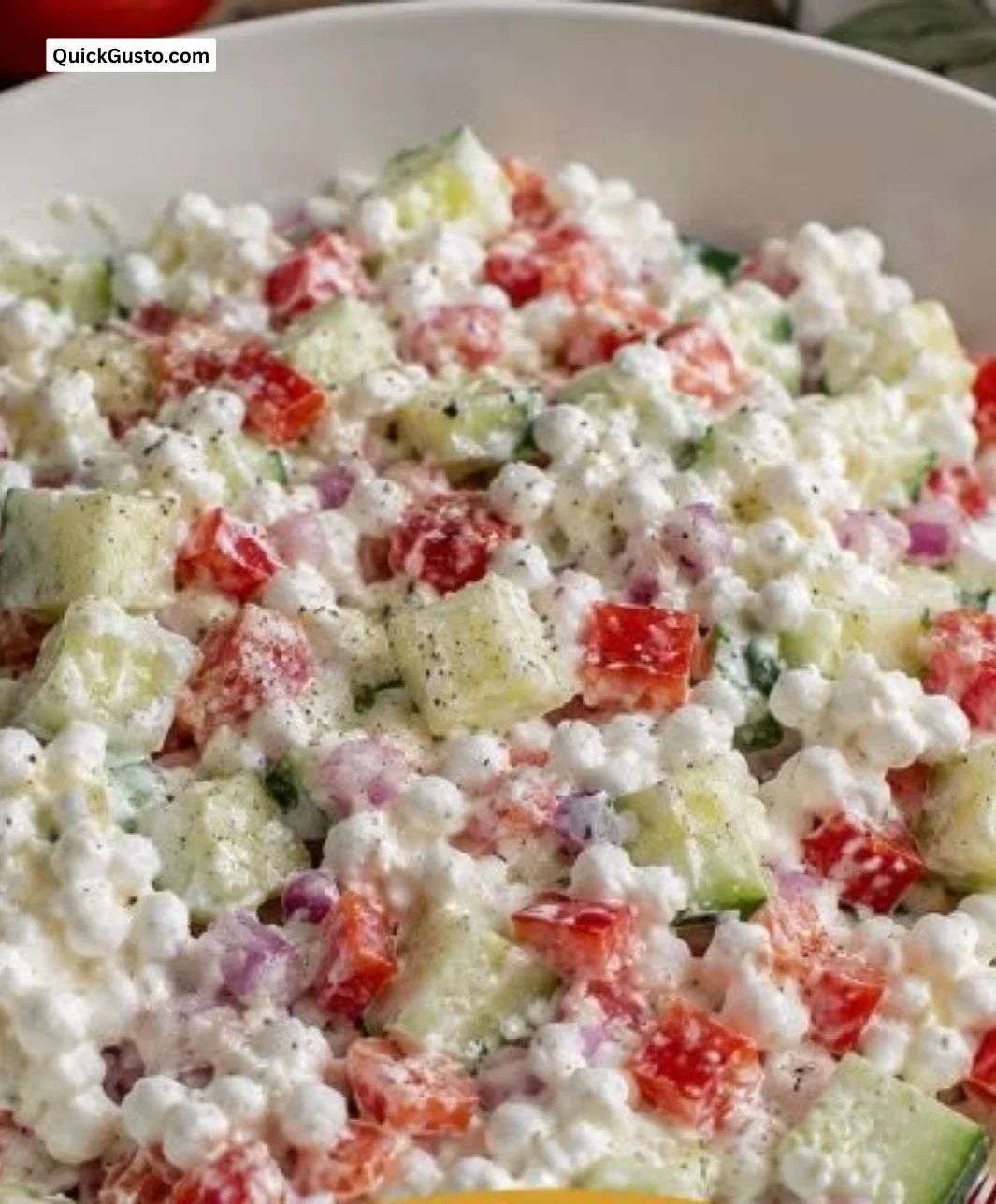 Colorful cottage cheese salad with fresh vegetables and herbs.