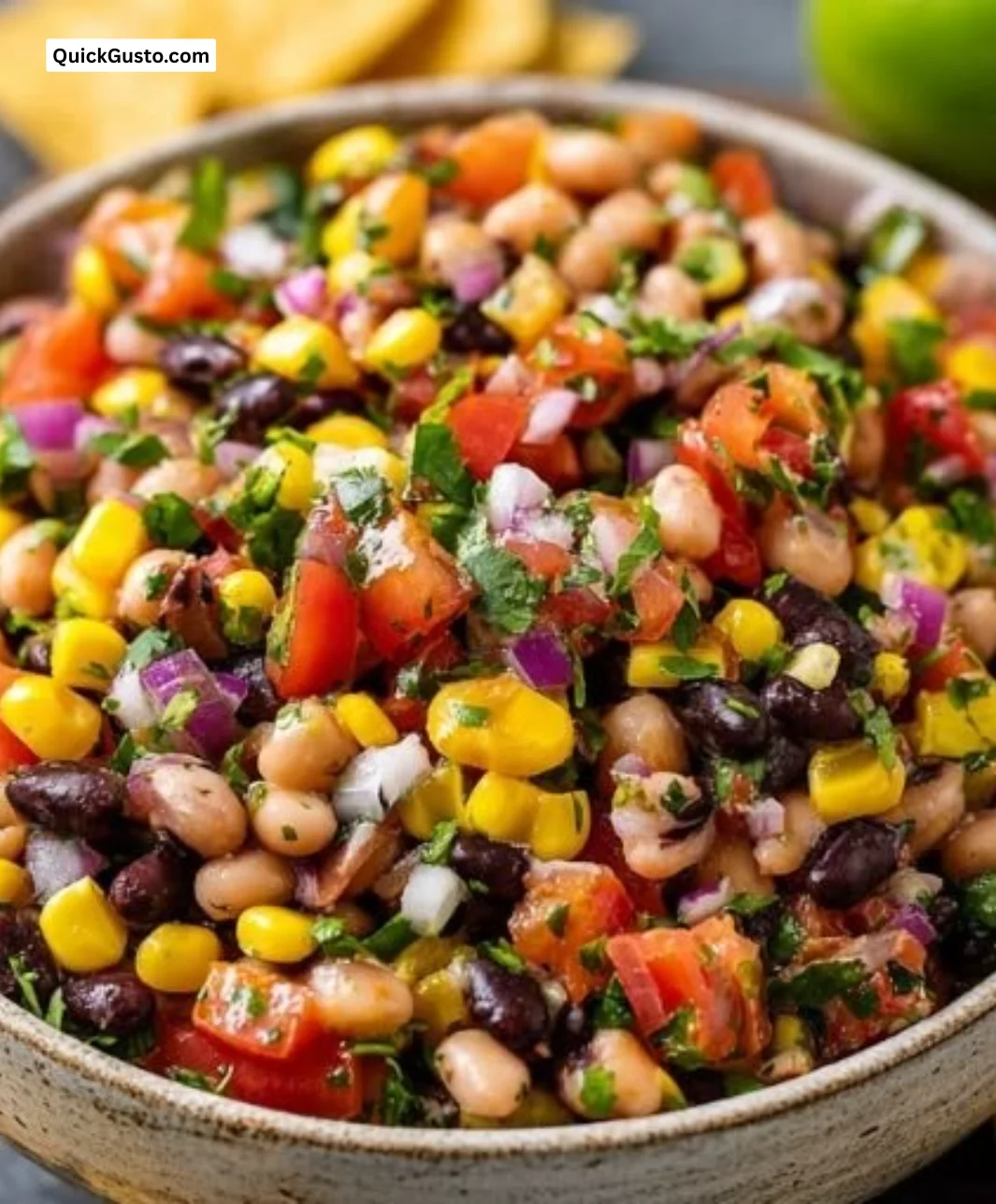 Bowl of colorful Cowboy Caviar with beans, corn, and vegetables.