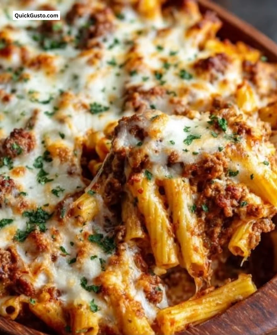 Cozy baked ziti dish with Italian sausage, cheese, and herbs, served in a casserole.