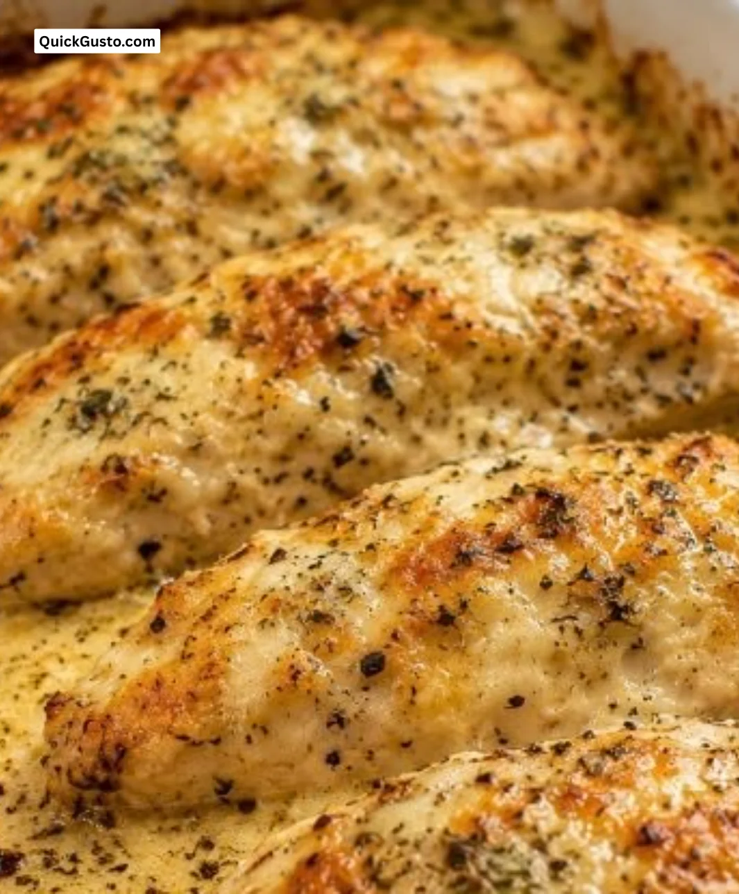 Creamy ranch baked chicken served on a plate with fresh herbs and sides