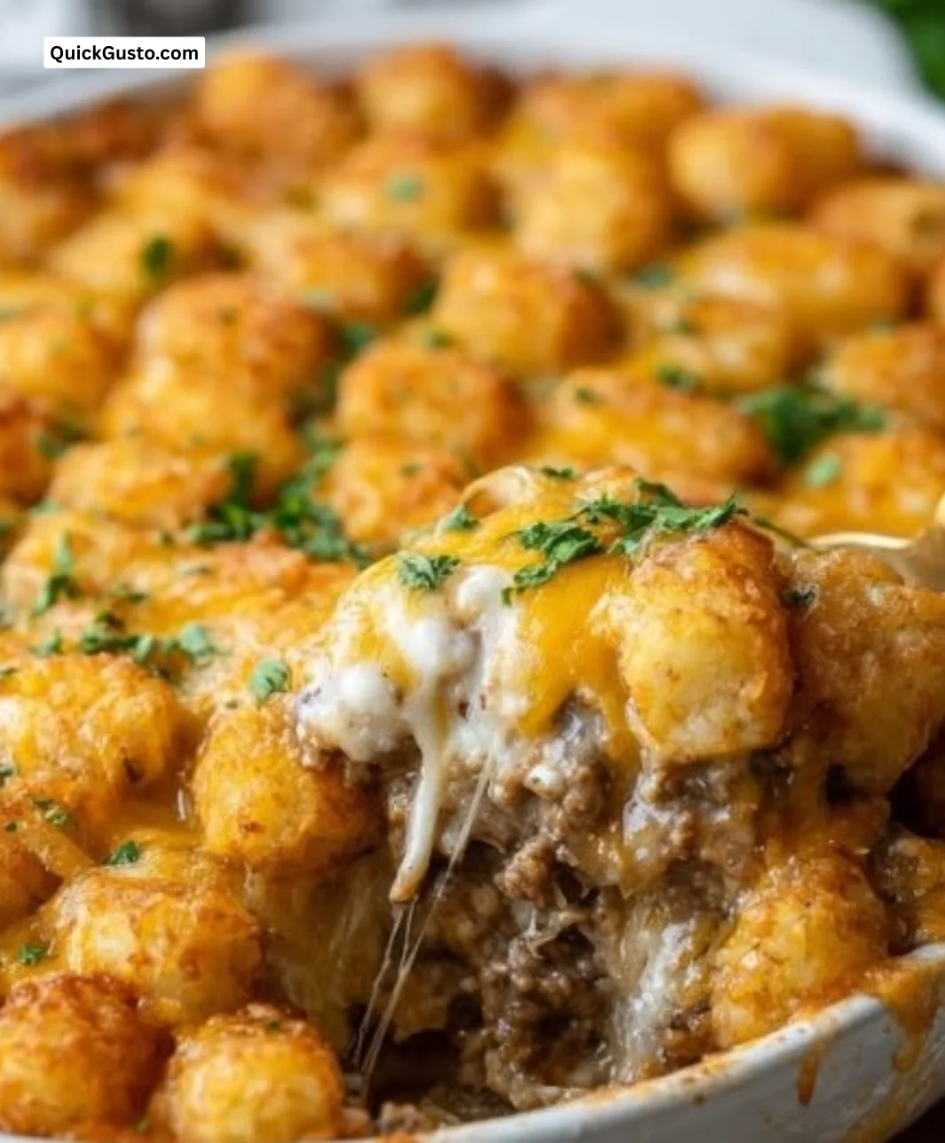 Delicious crispy tater tot casserole served in a cozy kitchen setting.